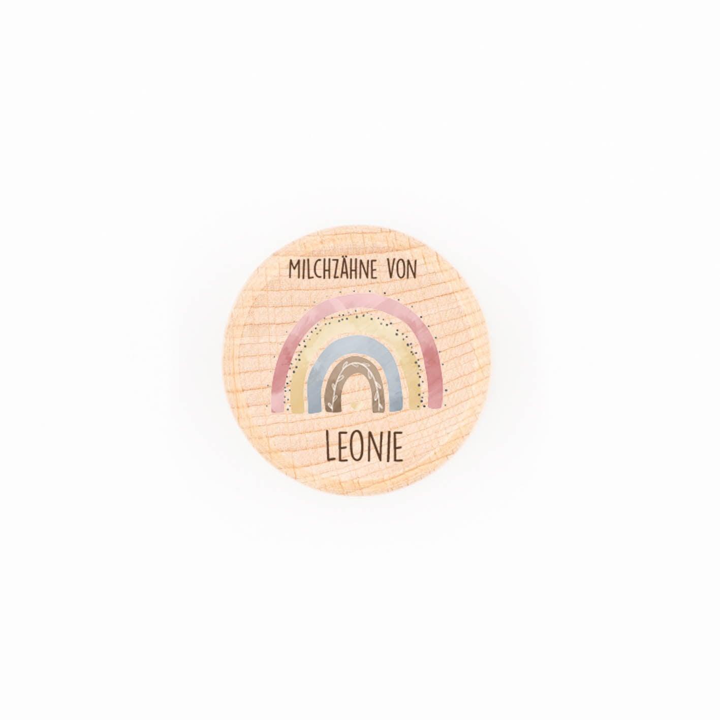 Personalized wooden milk tooth box featuring a rainbow design and name Leonie, perfect for storing baby teeth.